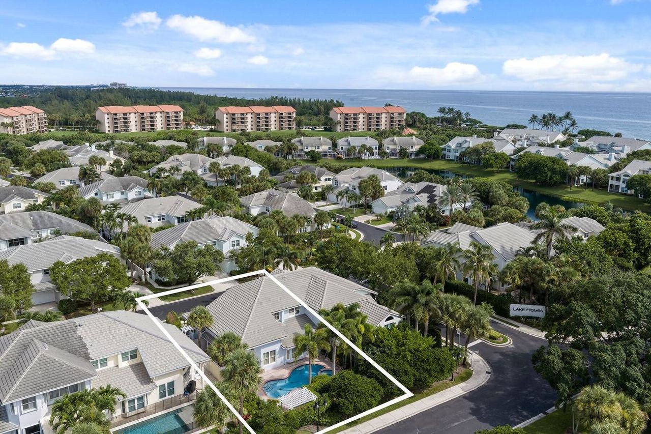 Aerial of the home outlined in the Sea Colony Lake Homes section, with the lake and ocean beyond
