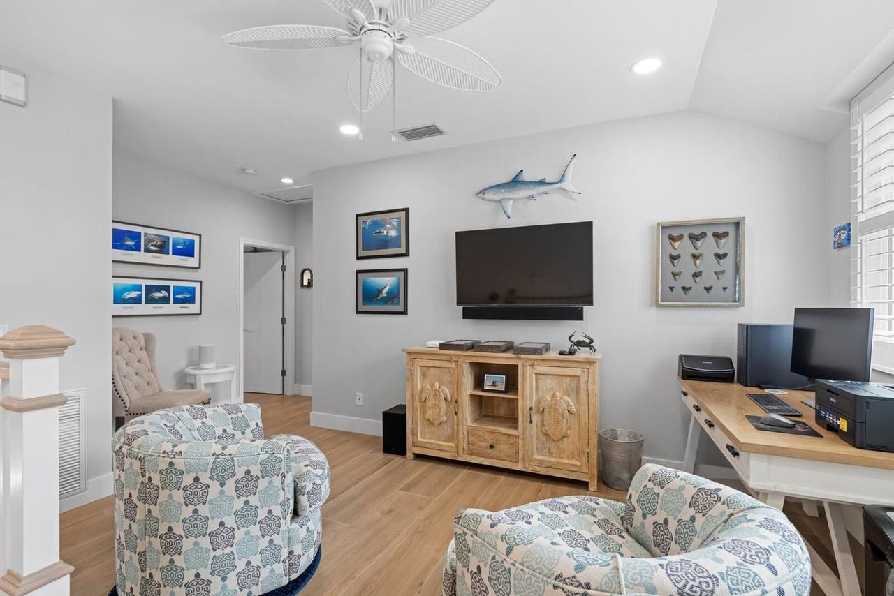 Upstairs loft with wood-look porcelain tile, used as an office and TV room