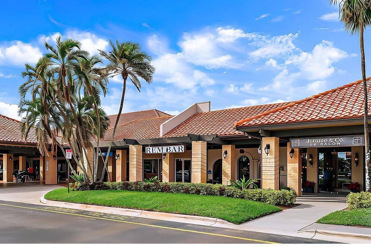 Bluffs Square Shoppes with REM Bar and Jerome & Co. salon under palm trees, near Sea Colony in Jupiter