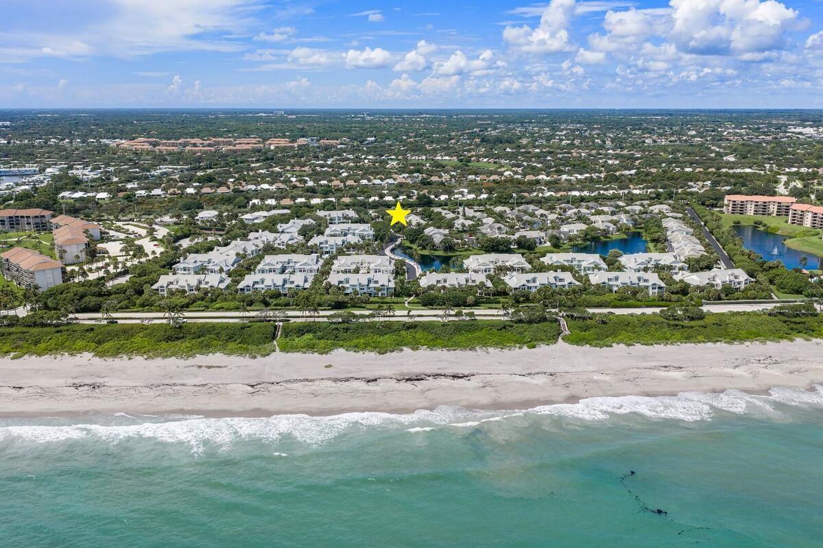 Aerial view of Sea Colony across A1A from Jupiter Beach, with the home marked by a star