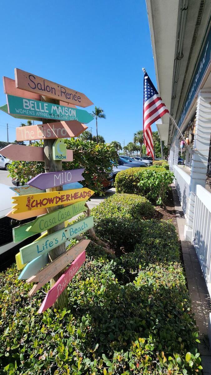 Beach-town signposts at the shops by Jupiter Beach